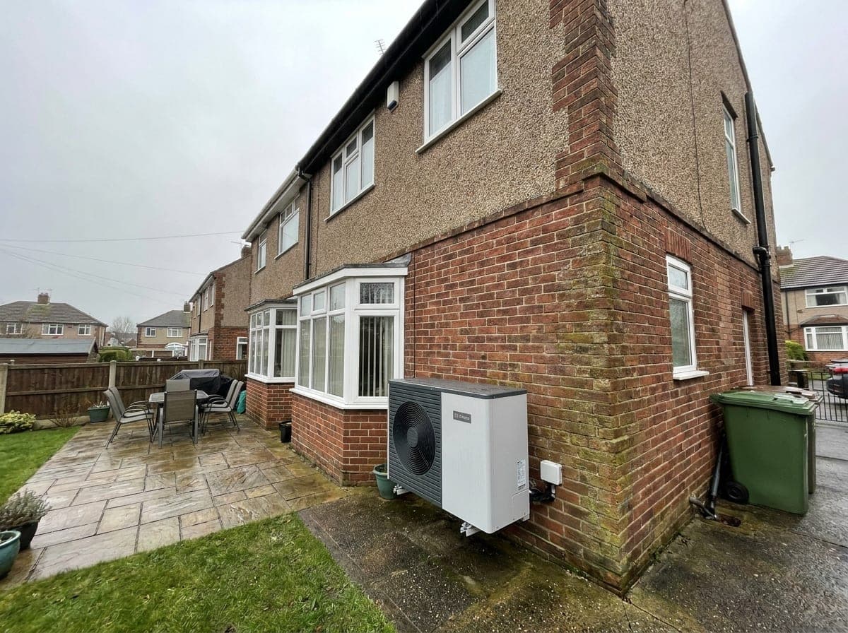 Air source heat pump installed beside a 1930s UK semi-detached house
